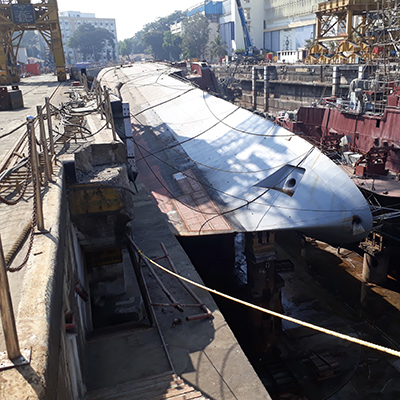 The INS Betwa on her side tied to a dock