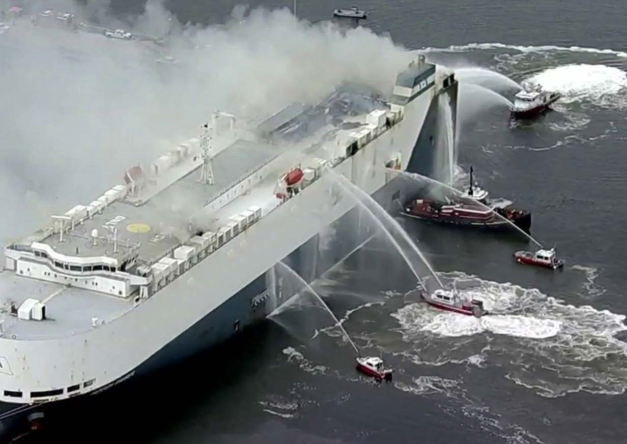 Several fire-rescue boats spray the vessel MV HOEGH XIAMEN with water