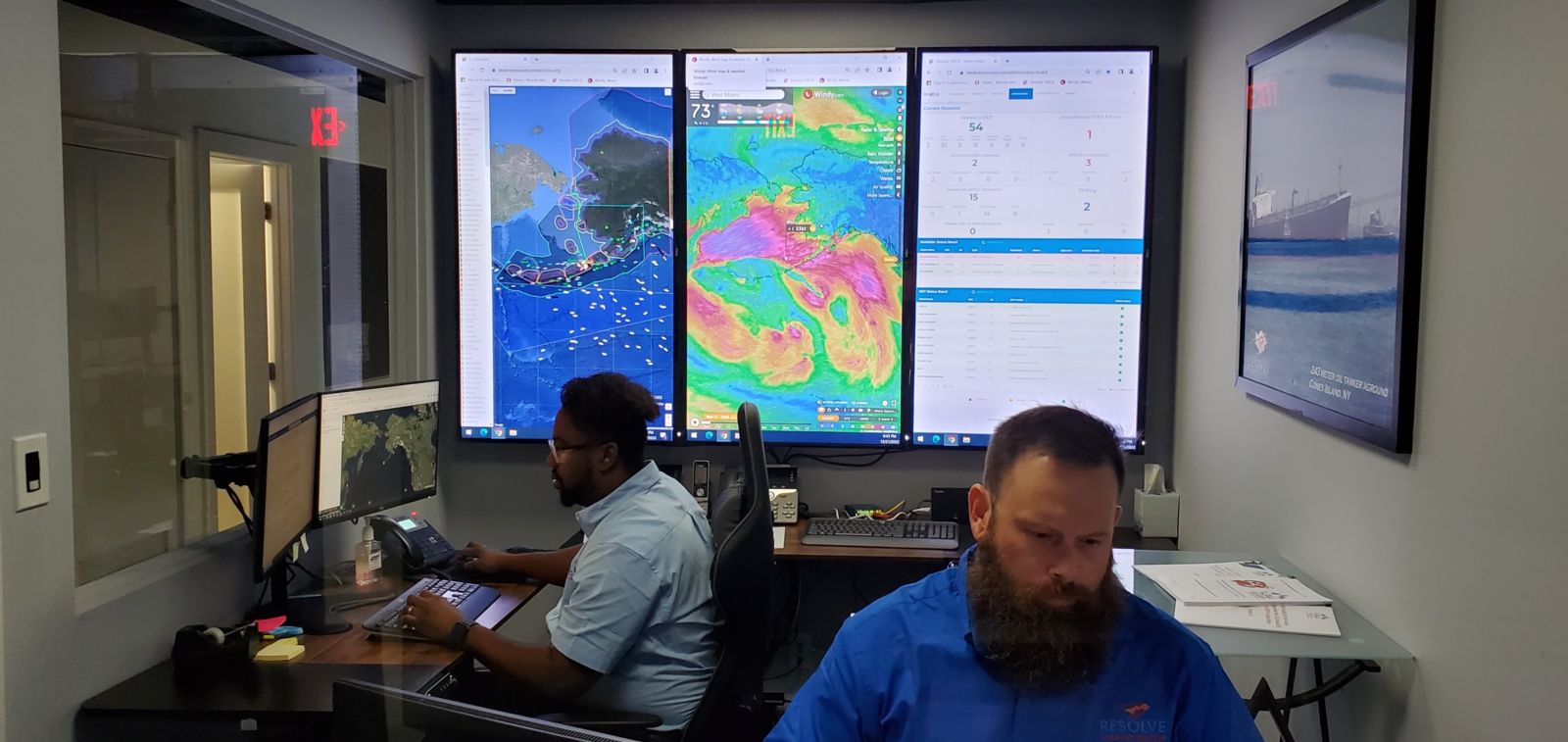 Inside view of two duty officers at Resolve Marine's in-house vessel tracking centers in Fort Lauderdale, Florida
